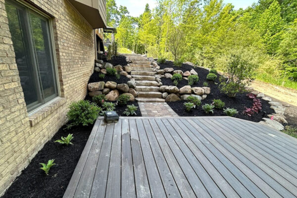 Mulched landscape beds with paver steps and plantings