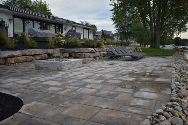 Lakefront paver patio with stone seawall