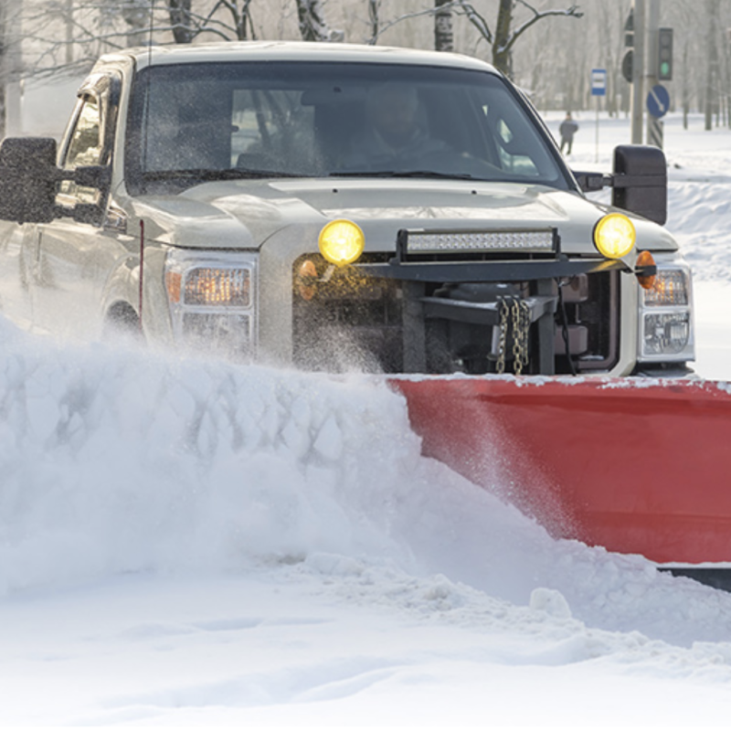 Plow truck performing commercial snow removal