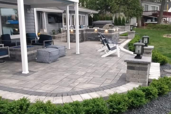 Brick paver patio with gas fire put and outdoor kitchen